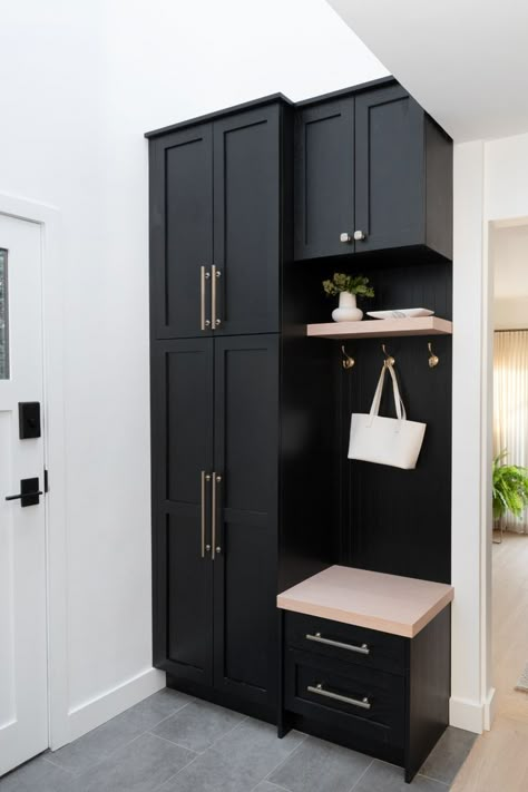 Our client has a busy family and was lacking storage solutions in the entryway. We designed this custom black cabinet to contain their jackets, shoes and provide additional storage when needed. #interiordesign #interiordesigner #canadiandesigner #midcenturymodernentryway #scandinavian #midcenturymodern #blackcabinetry #custommillwork Small Entryway Design, Small Entryway Shoe Storage, Small Entryway Shoe Storage Ideas, Hallway Storage Cabinet, Entryway Shoe Storage Ideas, Small Entryway Ideas, Small Mudroom Ideas, Entryway Storage Cabinet, Mudroom Remodel