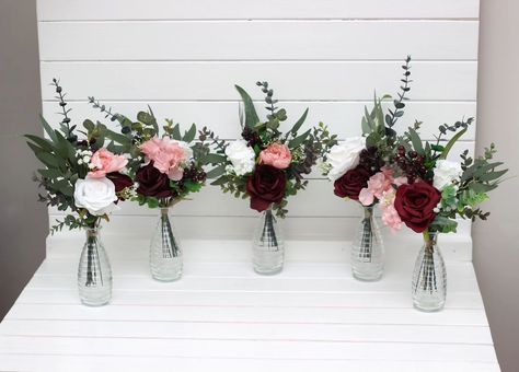 These chic wedding centerpieces blend classic elegance with a modern twist. Featuring rich burgundy, delicate blush, and crisp white florals, accented by lush greenery, they’re perfect for adding a touch of sophistication to your special day. 🌸🌿✨ #centetpieces #tabledecor #tableflowers #weddingarrangement #weddingflowers #burgundywedding #fauxflowerarrangement #artificialflowers #weddindflorist #weddingvendor Burgundy Flower Centerpieces, Burgundy And Blush Wedding Flowers, Bouquet Fall Wedding, Ivory Bouquet, Faux Bouquet, Mini Bouquets, Burgundy And Blush Wedding, Blush Bouquet, Blush Wedding Flowers