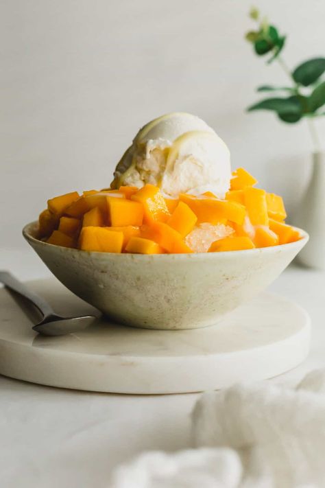 Mango shaved ice in a beige bowl, with a scoop of ice cream on top. Mango Shaved Ice, Mango Bingsu, Rice Ice Cream, Condensed Milk Ice Cream, Scoop Of Ice Cream, Ice Shavers, Ice Cream Toppings, Shaved Ice, Condensed Milk