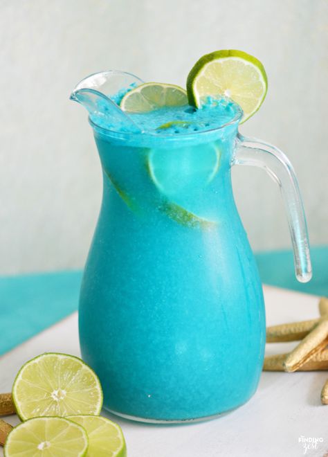 Throwing an mermaid, pool or ocean themed party? This Mermaid Punch recipe is quick and delicious featuring tropical flavors! Your guests will love this blue pina colada punch! Blue Pina Colada, Mermaid Punch, Pina Colada Punch, Blue Punch Recipe, Ocean Themed Party, Tropical Mermaid, Party Punches, Mermaid Food, Tropical Drink Recipes