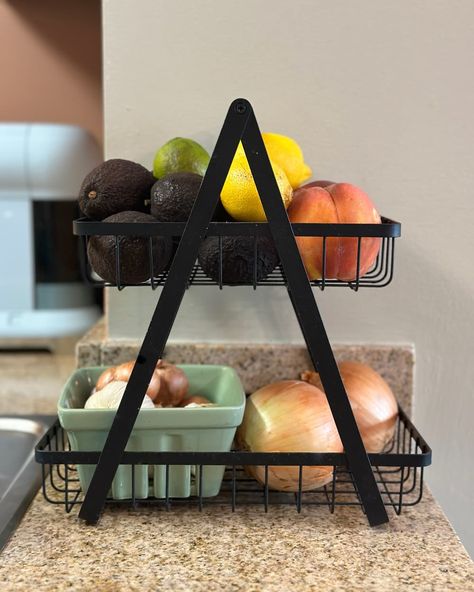 2 tiered fruit and vegetable stand full of fruits and vegetables on counter Fruit And Vegetable Storage Counter, Countertop Produce Storage, Fruit Counter Storage, Fruit Holder Ideas Kitchen, Counter Fruit Storage, Fruit On Counter, Fruit Basket Ideas Kitchen, Fruit Storage Ideas, Veggie Storage