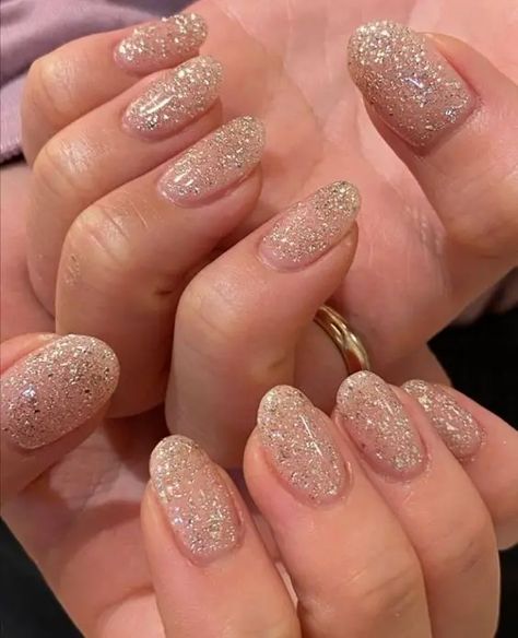 40+ Trendy Christmas Nails To Try This Holiday Season (2023) Beige With Glitter Nails, Glitter Nails Natural Nail, Beige Nails Sparkle, Short Round Sparkly Nails, Gold Sparkle Nails Short, Gold Sparkle Gel Nails, Nail Inspo Shimmer, Minimal Sparkle Nails, Sparkly Round Nails