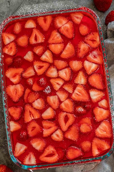 A delicious creamy layered jello recipe loaded with fresh fruits! A creamy layer of jello with cool whip and strawberries topped with classic jello. Creamy Jello, Jello Salad Recipes, Strawberry Jello Dessert, Layered Jello Recipe, Jello With Cool Whip, Raspberry Pretzel Salad, Jello Deserts, Strawberry Jello Salad, Jelly Salad