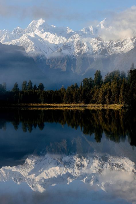 Lake Matheson, near the Fox Glacier in South Westland, New Zealand, is famous for its reflected views of Aoraki/Mount Cook and Mount Tasman. A traditional mahinga kai (food gathering place) for Maori people, the lake contains long finned eel as well as being home to many water birds. Lake Matheson New Zealand, New Zealand Mount Cook, Waitakere Ranges New Zealand, New Zealand Lakes, Lake Takepo New Zealand, Aoraki Mount Cook, New Zealand Mountains, Mt Taranaki New Zealand, New Zealand Tourist Attractions