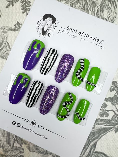 🕷️ Beetlejuice inspired 3D press on nails, set of 10 🕷️ Hand painted press on nails made to order using soft gel full cover press on nails in your choice of shape & length (however this design can't really be done on the short nails).  Includes some amazing 3D sandworms on 4 of the nail set. Colours include black & white striped nails, purple glitter, purple & green drip effect & the amazing sandworms. 🖤 These are handpainted press on/false nails so can be altered to your taste for a small fe Beetlejuice Short Nails, Beetlegeuse Nails, Beetle Juice Nail Art, Bettle Juice Nail, Bettle Juice Nail Ideas, Beetlejuice Nails Short, Beetlejuice Nails Acrylic, Beetlejuice Nail Designs, White Striped Nails