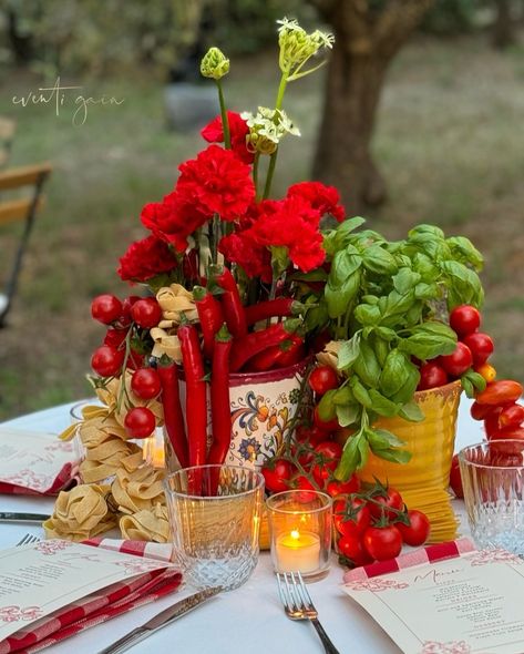 Channeling ultimate Italian vibes with this gorgeous table setup! 🍅🌿 Red carnations paired with fresh basil, tomatoes, chili peppers, and pasta make for a deliciously rustic centerpiece. Perfect for any Italian-inspired dinner party! 🇮🇹✨ #ItalianDining #TableDecor #FoodInspiration #DinnerParty #RusticElegance #eventigaia #weddingplanner #destinationwedding Rustic Italian Centerpieces, Sicily Party Theme, Italian Family Style Dinner Party, Tomato Table Decor, Pasta Party Decorations, Italian Centerpieces Table Decorations, Tomato Centerpiece, Italian Flower Arrangements, Italian Dinner Party Decor