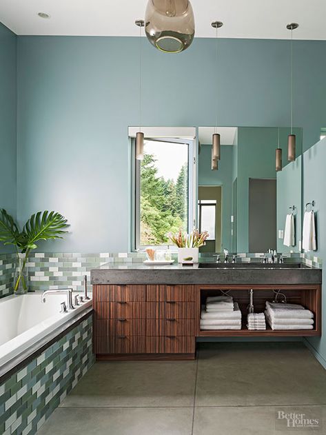 Dusty Teal + White + Mocha - Just like in nature, various shades of green play well together. Layer light and dark shades of a single hue in your bathroom backsplash with a neutral accent color such as white. This rich teal wall color strikes a pleasing note between green and blue. The bluish green emits cool luxury against a warm wood vanity. Relaxing Bathroom Colors, Calming Bathroom Colors, Teal Wall Colors, Blue Green Bathrooms, Bath Trends, Relaxing Bathroom, Bathroom Color Schemes, Teal Walls, Bathroom Paint Colors