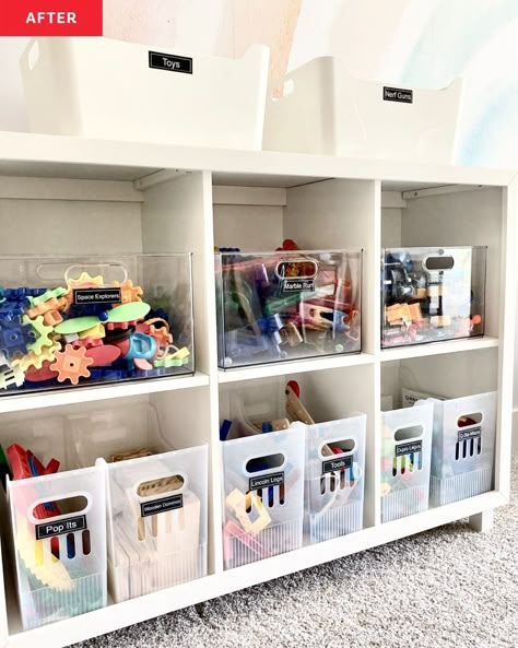 white cubby storage shelves, storage bins with labels, storage bins on top of shelves, rainbow mural, carpet Kids Art Supplies Organization, Cubby Organization Ideas, Organizing Toddler Toys, Playroom Organization Small Space, Toy Room Organization On A Budget, The Home Edit Playroom, Classroom Toy Storage, Toy Organization For Small Spaces, Playroom Closet Organization