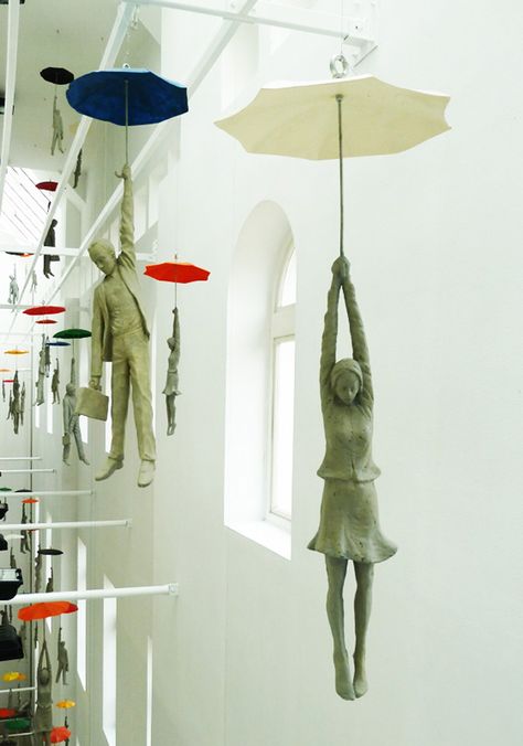 These cement figures dangling from umbrellas within a narrow space inside the EBC office center in Prague are part of a installation titled Slight Uncertainty by Czech artist Michal Trpák. Check out much more of his sculptural work on his website. Umbrella Art, The Ceiling, Sculpture Installation, Land Art, Public Art, Art Plastique, Art Sculpture, Ceramic Sculpture, Prague