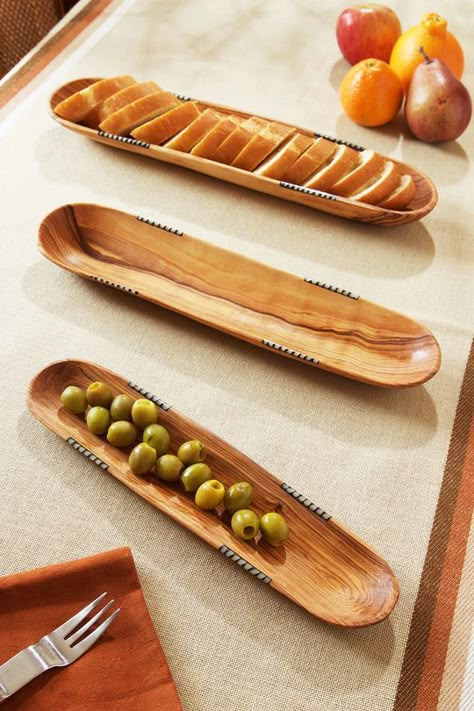 Hand carved from wild olive wood by Kamba carvers living in Eastern Kenya, these all-natural trays are sized perfectly for serving up baguettes and crackers. Dyed cow bone inlay adds a distinctively African touch. Natural wood grain and bone inlay will vary. Wooden Cups, Wood Serving Platter, Wild Olive, Wood Dishes, Wooden Platters, Wooden Salad Bowl, Wood Trays, Wooden Dishes, Wooden Trays