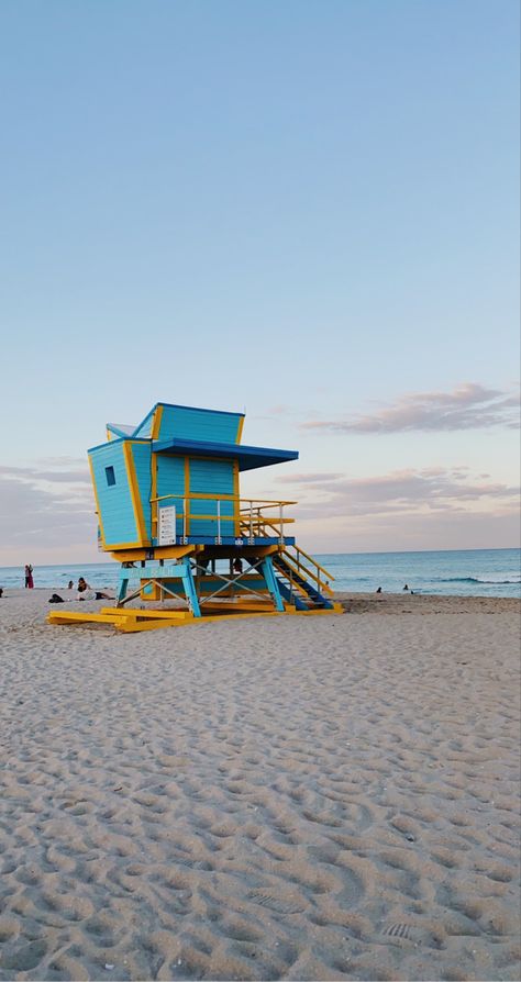 Miami Beach lifeguard sunset mood boarrd sand sky Miami Lifeguard Tower, Lifeguard Stand, Miami Beach Lifeguard Tower, Miami Beach House, Beach Lifeguard, Lifeguard Stands, Googie Architecture, Lifeguard Tower, Mughal Architecture