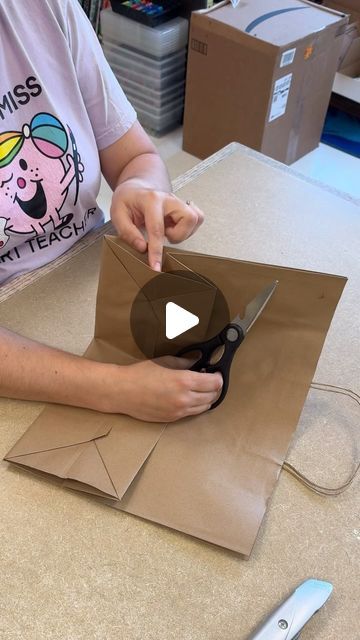 Katie Allain 🎨 on Instagram: "Paper Bag Portfolio Prep!! I learned this awesome trick from @nylah.khan years ago and have been using it ever since. Most of our paper bags we use for portfolios are donated. (Love @traderjoes bags because they are so sturdy) but I do buy extras to make sure we have enough for all the students.   We start by trimming off the two short sides of the bottom panel. We fold down the rectangle panel to flatten the bag. Next, you can reach your arms into the bag and pop out the gussets to flatten the bag into a perfect flat folder to safely hold all of the student’s 2D artworks for transporting home. The handles make carrying them easy for little hands and the bags extend wide enough to fit large format artworks! They are our favorite way to organize and bring home Paper Bag Art Portfolio, Decorating Plain Gift Bags Brown Paper, Paper Bag Portfolio, Brown Paper Bag Vest, How To Make Carry Bag With Paper, Large Paper Bag Crafts, Grocery Paper Bag Crafts, Butcher Paper Gift Wrap Ideas, Decorating Brown Paper Bags