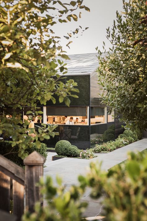 The familiarity and warmth of the burned finish juxtapose the more contemporary fritted glass that wraps around the corner of the building. Courtyard Renovation, French Laundry Restaurant, Yountville California, Kitchen Expansion, Fritted Glass, Laundry Kitchen, Glass Facade, The French Laundry, Thomas Keller