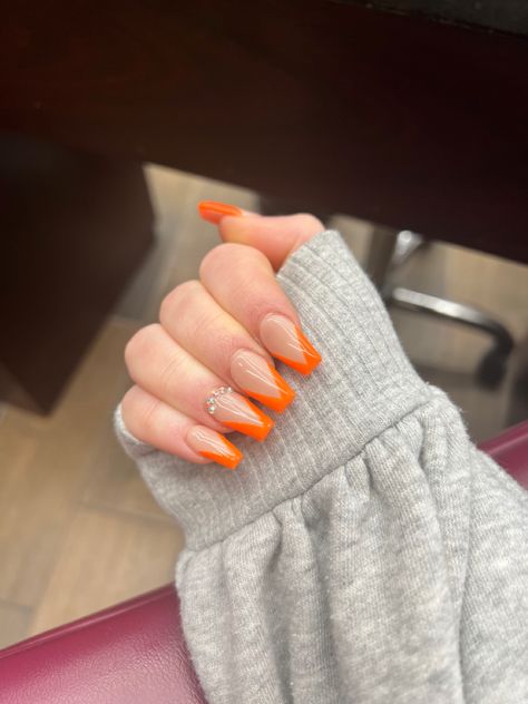 Orange Glitter Tips Acrylic Nails, Tangerine French Tip Nails, Orange French Tip With Rhinestones, White Nails With Orange Tips, Neon Orange Nails French Tip, Neon Orange And White Nails, Orange And White Prom Nails, Neon Orange Prom Nails, Blue And Orange French Tip Nails