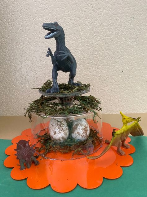 Easy DIY dinosaur center piece for your child’s birthday. Dino Centerpiece Party Ideas, Dinosaur Table Decorations, Dino Centerpiece, Dinosaur Centerpieces Ideas, Dino Train, Third Birthday Boys, T Rex Cake, Jurassic Park Birthday Party, Fake Moss