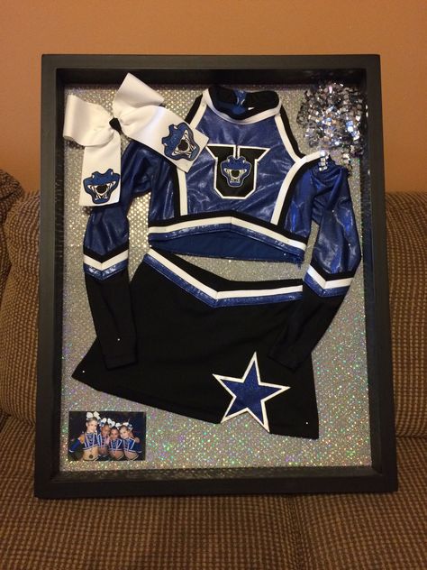 Shadow box cheer uniform Framed Cheer Uniform, Cheer Shadow Box Ideas, Cheer Uniform Shadow Box, Cheerleading Bedroom, Dance Hacks, Cheerleading Crafts, Cheer Team Shirts, Cheer Box, Shadow Box Ideas