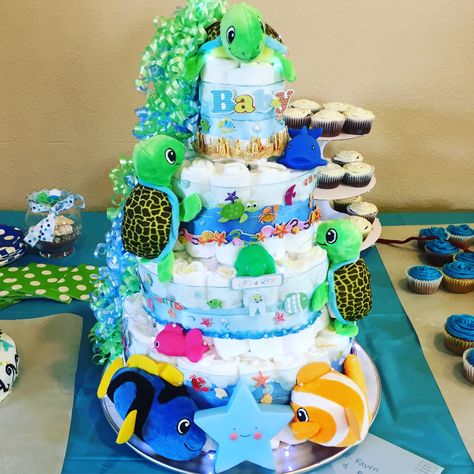 A turtle 🐢 / under the sea 🌊 themed diaper cake! #babyshower #babyshowers #diapercake #dispercakes #turtlethemedcake #turtlethemedcakes #undertheseathemeddiapercake #undertheseathemeddiapercakes #candyscreations Turtle Gender Reveal, Gender Reveal Under The Sea Theme, Sea Turtle Gender Reveal, Turtle Themed Baby Shower Ideas, Sea Turtle Baby Shower Ideas, Turtle Baby Shower Theme Boy, Turtle Diaper Cake, Turtle Baby Shower Theme, Cake Under The Sea