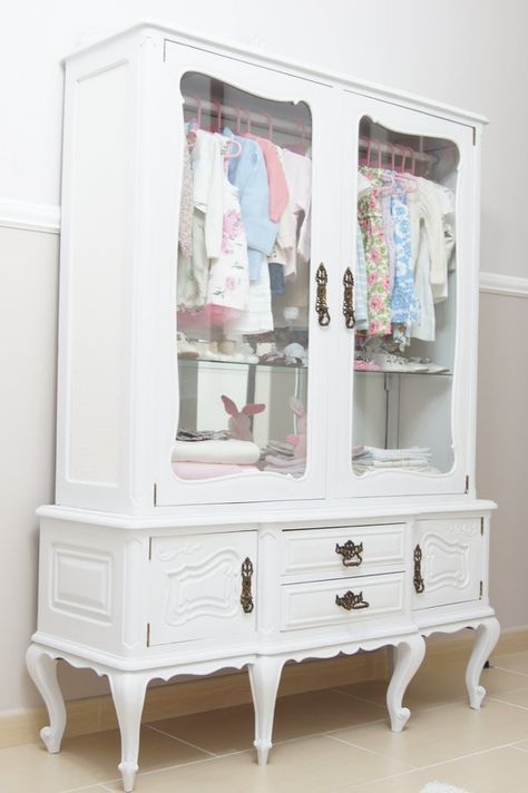 Repurpose a vintage china cabinet into a little girl's clothing armoire: just paint a pretty updated color add rod for hanging clothes-- can use optional shelves for folded clothes or add cute storage baskets, leave glass doors uncovered or add pretty fabric. Wonder if this would work with hubby's old gun cabinet? | Do It Darling China Cabinet Closet, China Cabinet Kids Room, Vintage China Cabinet, Purse Closet, Clothing Armoire, Vintage China Cabinets, Folded Clothes, Cute Storage, Clothing Closet