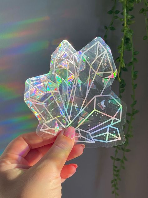 Add a touch of magic to your windows with these holographic suncatcher stickers! They'll create a beautiful rainbow effect when the sun shines through them. #suncatcher #windowdecor . #Cricut_Suncatcher_Sticker #Holographic_Decor #Witchy_Store #Suncatcher_Stickers Witchy Store, Suncatcher Stickers, Diy Foil, Suncatcher Sticker, Cricut Stickers, Suncatcher Diy, Jewelry Packaging Design, Crystal Stickers, Holographic Stickers