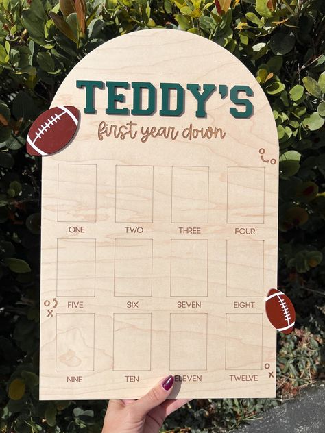 This beautifully crafted one year down photo board is the perfect way to commemorate your little one's first year! Names are 3D done in dark green wood, footballs are down in brown and white acrylic, all other elements are perfectly engraved.  Show off your baby's 12 monthly milestones on one of our first year picture board.  This is perfect to display at a birthday party and keep as a room décor after.   DETAILS * Sizing options are shown in photos (all board will be FOOTBALL boards, the size p First Down 1st Birthday Party, Football First Birthday Food, 1st Down Football Birthday Party Food, First Year Down Birthday Party Food, One Year Old Football Birthday Party, First Year Down Football Birthday Food, One Year Party Theme, Rookie Year First Birthday Football, First Year Down Birthday Party