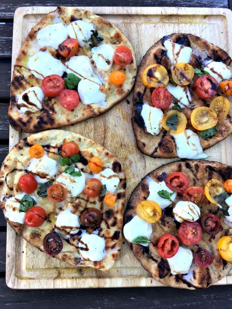 These grilled naan pizzas are what summer is all about! Fresh tomatoes, basil, and mozzarella all toasted up on naan bread on the grill. Make the tonight! Naan Grilled Pizza, Naan Pizza On The Grill, Naan Bread Pizza On The Grill, Bread On The Grill, Bbq Chicken Pizza Naan Bread, Tomato Mozzarella Flatbread, Tomato Basil Mozzarella Flat Bread, Dinner Ides, Naan Pizzas