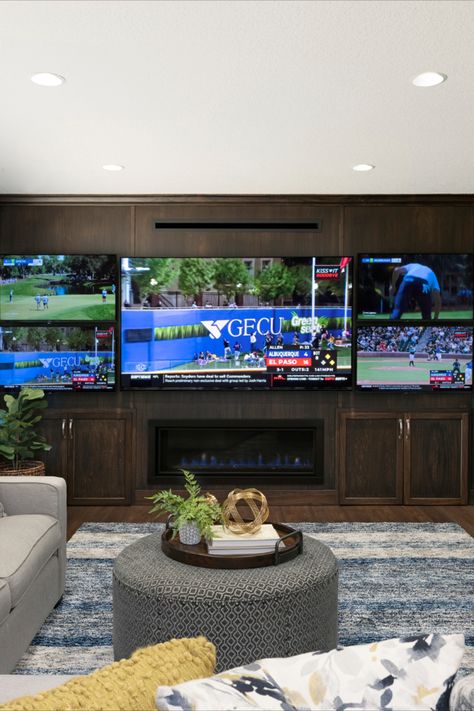 televisions, sports, rug, blue rug, grey couch, home decor, dark wood, dark stained wood, fireplace, electric fireplace, built ins, recessed lighting, ottoman, knockdown ceiling, pillows, gold, nickel hardware Tv Wall Multiple Tvs, Media Room With Multiple Tvs, Game Room Tv Wall Ideas, Game Room Multiple Tvs, Two Tvs In One Room Ideas Tv Walls, 4 Tvs On One Wall Game Room, Multiple Tv Wall, Tv Sports Room, Basement Multiple Tv Wall Ideas