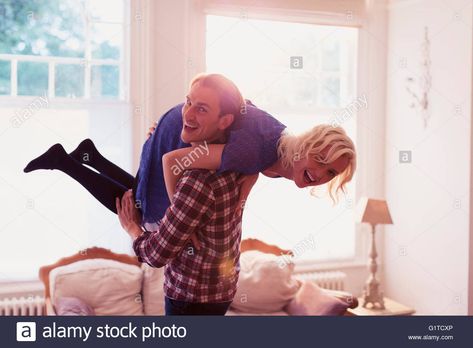 Download this stock image: Portrait playful husband carrying wife over shoulder in living room - G1TCXP from Alamy's library of millions of high resolution stock photos, illustrations and vectors. Over The Shoulder Carry Pose, Carrying Over Shoulder Pose, Husband Carrying Wife, Carrying Someone, Shoulder Pose, Couple Poses Drawing, Human Poses Reference, Best Photo Poses, Photo Poses For Couples