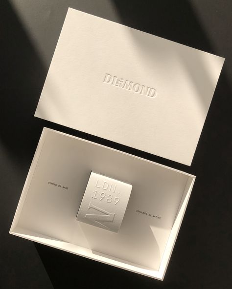 Custom box with platform made for Dimond London Design by Coralie Carre Blind debossing on the lid, black foil stamping inside and outside bottom lid. Blind embossing on the inner box sleeve. Paper: 2mm White Sumo Board Favini Papers #packaging #rigidbox #jewellerypackaging #lidandtrayboxes #packagingdesign ##packaginginspiration #embossing #debossing Fashion Box Packaging, Fashion Business Cards Creative, High End Packaging, Foil Stamping Design, Debossed Business Card, Rigid Box Packaging, Mailer Box Design, Custom Mailer Boxes, Jewelry Packaging Design