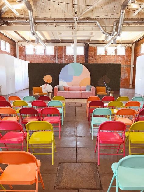 Bright and bold colorful folding chairs in a minimal, industrial event space Womens Conference Stage Design Backdrop Ideas, Production Studio Aesthetic, Colorful Stage Design, Colourful Portfolio, Pop Up Event Ideas, Conference Decor, Sp Studio, Event Space Design, Corporate Event Design