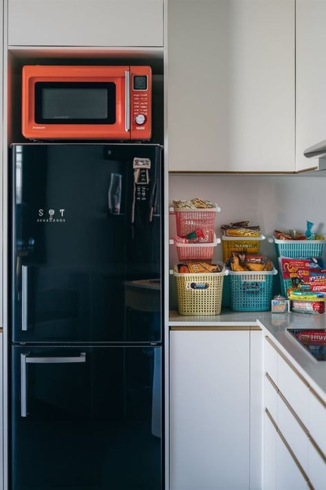 Microwave positioned on top of fridge in a small kitchen, optimizing space and organization. Microwave On Fridge, Microwave Over The Fridge, Microwave Above Fridge, Microwave On Top Of Fridge, Top Of Fridge Ideas, Where To Put The Microwave, On Top Of Fridge, Fridge Ideas, Over The Fridge