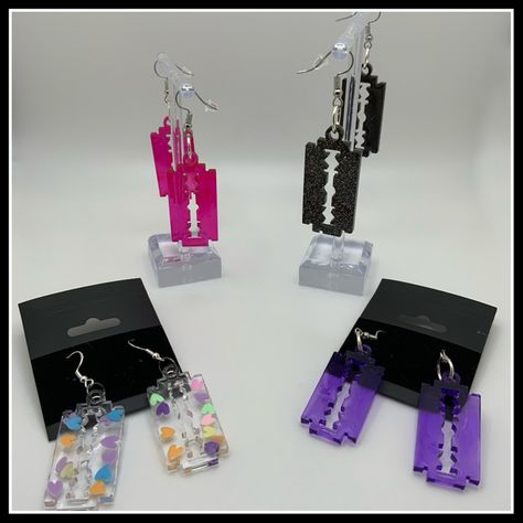 Borderlinepunkdesign has a large range of resin razorblade earrings, they add a sharp and tasteful flare to any outfit! Check them out! LINK IN BIOOOOO!!! Check out my instagram for more: @borderlinepunkdesign Thank you for supporting small businesses! Have a great day!!! #goth #razorearrings #resinearrings #artist Goth Small Business, Gothic Trench Coat, Skull Skirt, Pant Chains, Homemade Lip Balm, Audre Lorde, Vintage Jean Jacket, Music Recommendations, Outfit Check