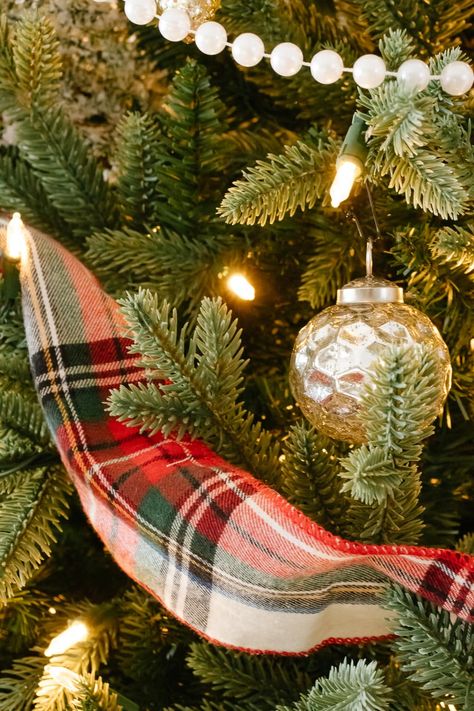 A Christmas tree filled with cozy flannel plaid ribbon, traditional pearl beaded garland and loads of beautiful mercury glass and mixed metal ornaments to create a vintage inspired Christmas tree with a cozy + nostalgic feel for the holidays. #vintagechristmas #christmastree #cozychristmastree #mercuryglass #mercuryglasschristmas #plaidchristmasdecor #nostalgicchristmasdecor #christmastreedecoratingideas Vintage Plaid Christmas Tree, Christmas Trees With Plaid Ribbon, Christmas Tree With Plaid Ribbon, Christmas Tree Plaid Ribbon, Plaid Decorated Christmas Tree, Christmas Tree Plaid Theme, Christmas Tree Ideas 2024 Trends, Plaid Ribbon Christmas Tree, Plaid Christmas Tree Ideas