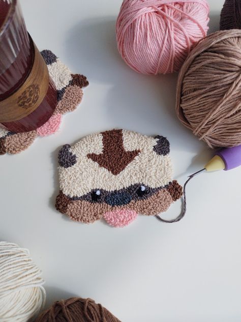 punch needle avatar appa Mario Punch Needle, Ghibli Punch Needle, Push Needle Ideas, Studio Ghibli Punch Needle, Push Needle Embroidery, Pokemon Punch Needle, Punch Embroidery Ideas, Harry Potter Punch Needle, Anime Punch Needle