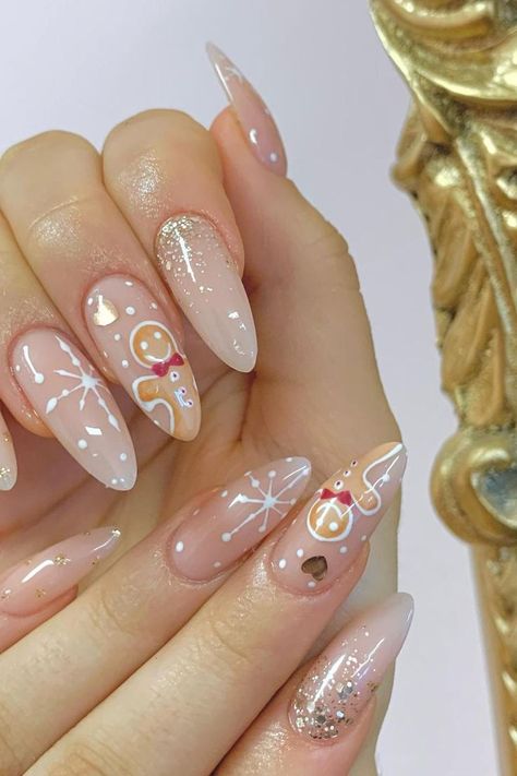 Gingerbread Sweetness: Soft pink almond nails adorned with adorable gingerbread man art and delicate snowflake designs create a holiday masterpiece that sparkles like fresh snow! // Photo Credit: Instagram @simplybeauty_bridgend Trendy Christmas Nails, Press On Acrylic Nails, Nails Festive, Snow Nails, Nails Nude, Christmas Nails Acrylic, Festival Nails, Xmas Nails, Hot Nails