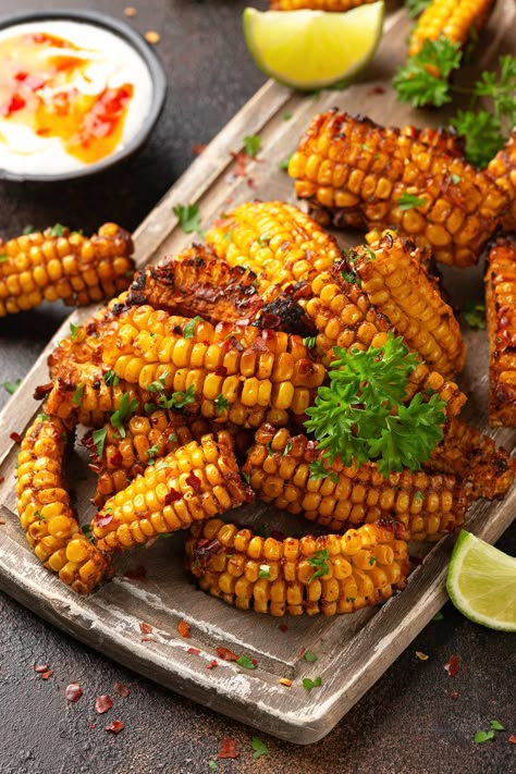 These Corn Ribs are perfect whether you want to amp up your appetizer game or add some pizzazz to your side dish repertoire. The sweet, juicy corn on the cobs are cut into rib-like strips seasoned with a lip-smacking rub before being barbecued, oven-baked, or cooked in the air fryer. Then, to finish, they are generously drenched in a pool of melted garlic lime butter. Corn Ribs, Bbq Corn, Memorial Day Foods, Seasoned Corn, Lime Butter, Meatless Main Dishes, Corn Recipes, Corn On The Cob, Corn On Cob