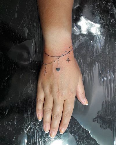 charm bracelet tattoo designs - Yahoo Search Results Tattoo Ankle Bracelet, Charm Bracelet Tattoo, Bracelet Tattoos, Wrist Bracelet Tattoo, Tattoo Ankle, Armband Tattoos, Bracelet Tattoo, Anklet Tattoos, Initial Tattoo