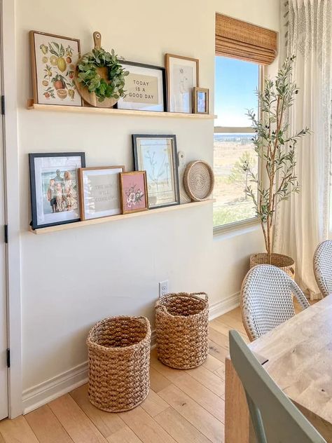 Long Open Wall Living Room, Shelves In Breakfast Nook, How To Style Picture Shelves, Open Hallway Decor, Dining Wall Shelves, Boho Floating Shelf Decor Living Room, Above Tub Decor, Wall With Shelves And Pictures, Family Room Wall Decor Ideas Above Couch