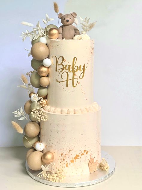 A two tier baby shower cake in neutral tones. Decorated with chocolte spheres, dried flowers, and topped off with handmade teddy bear fondant topper. Teddy Cake Topper, Two Tier Teddy Bear Cake, Teddy Baby Shower Cake, Boho Teddy Bear Cake, Teddy Bear Baby Shower Cake Boys, Simple Teddy Bear Cake, Boho Baby Shower Cake Boy, Boho Bear Baby Shower Ideas, Teddy Bear Baby Shower Theme Cake