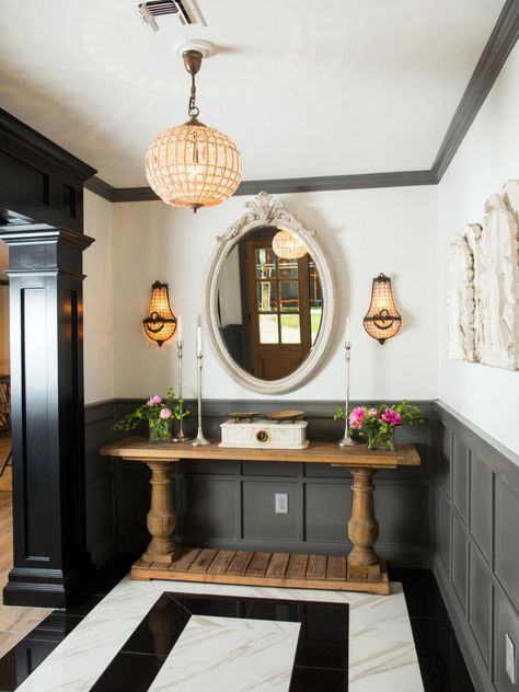 Sara's tastes run toward a nouveau classical look with an affinity for ornate furnishings and French antiques. The combination presented a decorating challenge for Joanna who frequently leans more in the direction of farmhouse country and rustic themes. This new foyer – highlighted by black and white marble floors, rich textures and dark gray paneling – offers a mix of contemporary elements and old world touches making for a carefully integrated look that marries comfort and style. Farmhouse Foyer, Hgtv Fixer Upper, 70s House, White Marble Floor, Latest Interior Design Trends, Decor Videos, Decor Ikea, Home Luxury, Black And White Decor