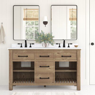 The distressed finish on this sleek 60" double vanity set brings tons of coastal farmhouse charm to your bathroom. Its freestanding frame is made from solid wood with an ash brown finish and wood scoring throughout for a rustic look. The white polished Carrara marble surface accommodates two porcelain undermount sinks (faucets sold separately), and it has a backsplash that protects your walls from splashes. Three central functional drawers give you a spot to keep various toiletries, while two sl Weathered Oak Vanity Bathroom, 60” Double Sink Bathroom Vanity, All Drawer Bathroom Vanity, Natural Powder Room, Organic Modern Master Bath, Lake Cabin Bathroom, 60 Inch Vanity One Sink, Small Double Vanity Bathroom, Bathroom Vanity Shelves