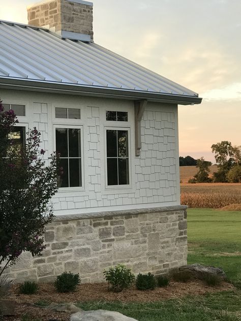 White House With Stone Wainscoting, Ranch House With Stone And Siding, White And Stone Farmhouse Exterior, Limestone On House Exterior, Stone At Bottom Of House, Cottage Exterior Stone, Stone Beach House Exterior, Flagstone Exterior House, Stone On Front Of Garage