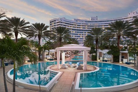 the resort pool at the Fontainebleau Fontainebleau Miami Beach, Fontainebleau Miami, Miami Beach Hotels, South Beach Hotels, Miami Hotels, Miami City, Hotel Exterior, Beachfront Hotels, Hotel Logo