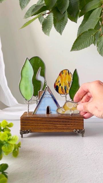 Stained Glass & Wood Artists on Instagram: "🌳🌲🏡🌲🌳The cabin scenes are one of our fave things to make … they just feel so peaceful. We’re gonna have some Little A-Frame in the Woods In tomorrow’s drop! Look for the timer In our stories! 🌳 . . #forestlovers #forestcore #cottagecore #cottagecoreaesthetic #cabindecor #homedecor #stainedglass #glassart #whimsicalart #intothewoods #wanderfolk #handmade #handmadeart #treehugger #treescape" Stained Glass Wood, Stained Glass Frames, Stained Glass Mosaic Art, Glass Painting Designs, Glass Mosaic Art, Cellar Door, Wood Artist, Stained Glass Diy, Cottage Core Aesthetic