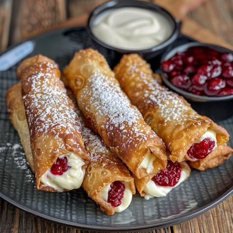 🍒 Air Fryer Cherry Cheesecake Egg Rolls – a sweet twist! #AirFryerMagic #DessertGoals Air Fryer Cherry Cheesecake Egg Rolls Ingredients: Cream cheese, softened (8 oz) Sugar (1/4 cup) Vanilla extract (1 tsp) Egg roll wrappers (10) Cherry pie filling (1 cup) Powdered sugar for dusting Instructions: Beat cream cheese, sugar, and vanilla until smooth. Place a spoonful of cheesecake mixture and cherry filling in each wrapper. Roll up and seal edges. Air fry at 375°F (190°C) for 8-10 minutes. D... Cheesecake Egg Rolls, Eggs Rolls, Recipe For Cheesecake, Fun Cheesecake Recipes, Cheesecake Mixture, Twist Recipes, Egg Roll Ingredients, Cream Roll, Cherry Filling