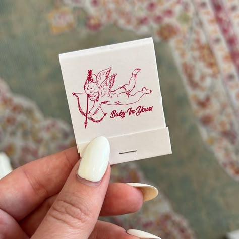 matchbook featuring a line drawn cupid and text “Baby I’m Yours”, front opens to reveal matches and striker on backside. Sweet Simple Wedding, Match Books Wedding, Match Book Design, Simple Wedding Details, Wedding Match Books, Wedding Matchbook Favors, Matchbook Tattoo, Custom Wedding Matchbooks, Baby Im Yours