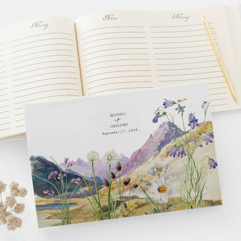 A beautiful watercolor wildflower and mountain wedding design. A unique design that uses watercolor wildflower botanicals and a watercolor mountain landscape in the background. A modern wild floral design with lakeside mountains and rivers. An elegant wedding guest book design with modern elements. Matching wedding invitations and other stationery items are also available. Wildflower Theme Wedding, Wildflower Mountain, Guest Book Design, Watercolor Mountain Landscape, Pretty Invitations, Illustrated Wedding Invitations, Wedding Boards, Rustic Watercolor, Holy Matrimony