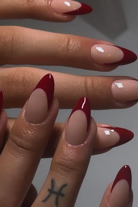 These almond-shaped nails offer a classic French manicure twist with a deep burgundy tip that adds a touch of sophistication. The natural nail base enhances the design, focusing attention on the bold color contrast. Perfect for those looking to combine timeless elegance with a splash of modern flair. ✨  // Photo Credit: Instagram @polishedbyykim Nail Almond Shape French Tip, Dark Red Nails Tips, French Nails Acrylic Almond Shape, Nail Design Almond Shape Classy, Almond Nails Burgundy French Tip, Dark Red French Tips Almond, Bold French Tip Nails, Bold Red Nails, Red Nails French Tip Almond