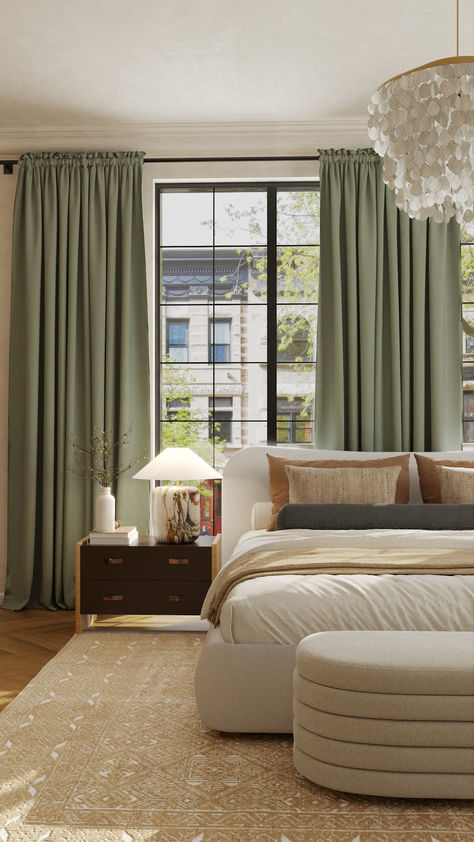 A cozy and elegant bedroom with a large window framed by green curtains, allowing natural light to fill the room. The bed, upholstered in beige, is decorated with neutral-toned pillows and a soft beige blanket. A dark wooden nightstand beside the bed holds a unique marble-patterned lamp and a small vase with branches. The floor is covered with a patterned, beige area rug, and a plush, rounded bench sits at the foot of the bed. Above, a luxurious chandelier. Plum And Sage Bedroom, Olive Green And Plum Bedroom, Sage Green And Purple Living Room, Green Purple Interior Design, Green And Plum Bedroom, Purple And Green Living Room, Teal Glassware, Aubergine Bedroom, Single Room Design