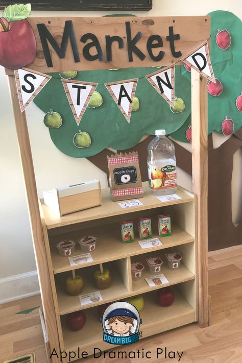 This is an apple themed dramatic play center for preschool, and kindergarten students.  Students can pretend to run an apple market where they buy and sell apple products; students can also pick apples from the orchard and make apple pie all while practicing math, literacy and social emotional skills. Market Dramatic Play Preschool, Pretend Play Apple Orchard, Diy Apple Stand Dramatic Play, Apple Orchard Preschool Dramatic Play, Apple Picking Dramatic Play Preschool, September Dramatic Play Center, Apple Orchard Dramatic Play Printables Free, Apple Stand Dramatic Play, Apple Picking Dramatic Play