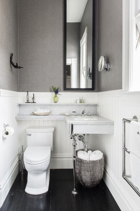 No space for a vanity? Consider adding a sink that runs parallel with the toilet and extends above it with attached, built-in shelving. Small Bathroom Wall Ideas, Powder Room Shelves, Dresser To Vanity, Toilet Countertop, Above Toilet Decor, Black Wooden Floor, Copper Bathroom Fixtures, Small Powder Rooms, Above Toilet